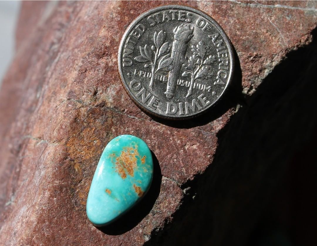 Blue Stone Mountain Turquoise cabochon w/ red matrix
Instagram    $7.50 for 2.6 carats untreated Nevada turquoise. 
